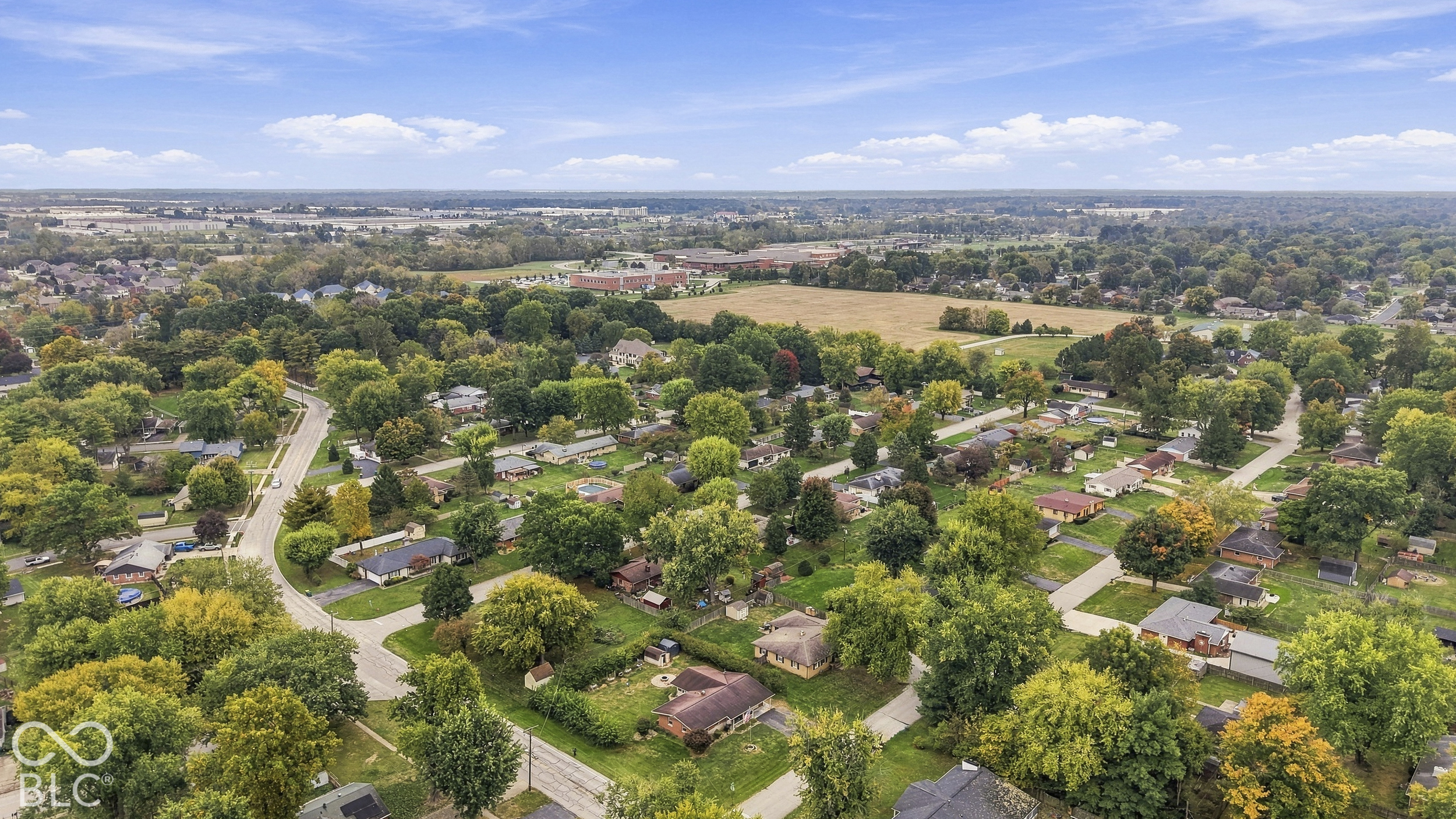 Aerial view of residential neighborhood featuring mature trees and established greenery