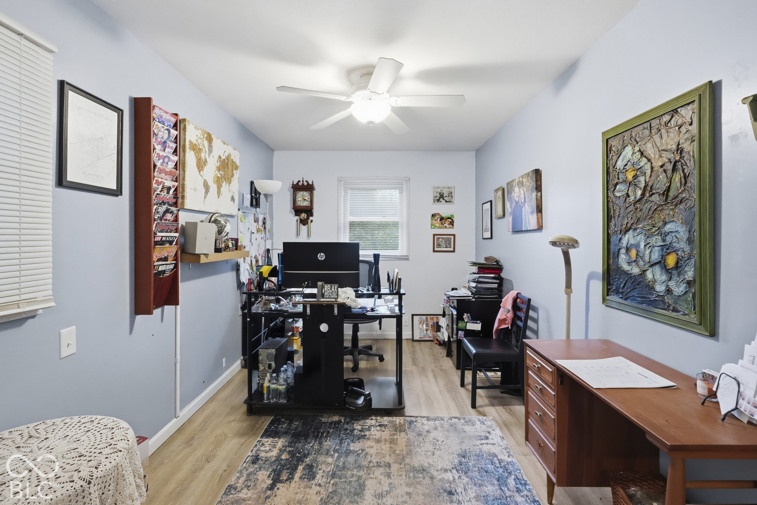 The dining room is being used as an office. It has a nice ceiling fan with integrated lighting, and horizontal window blinds. Vinyl plank flooring.