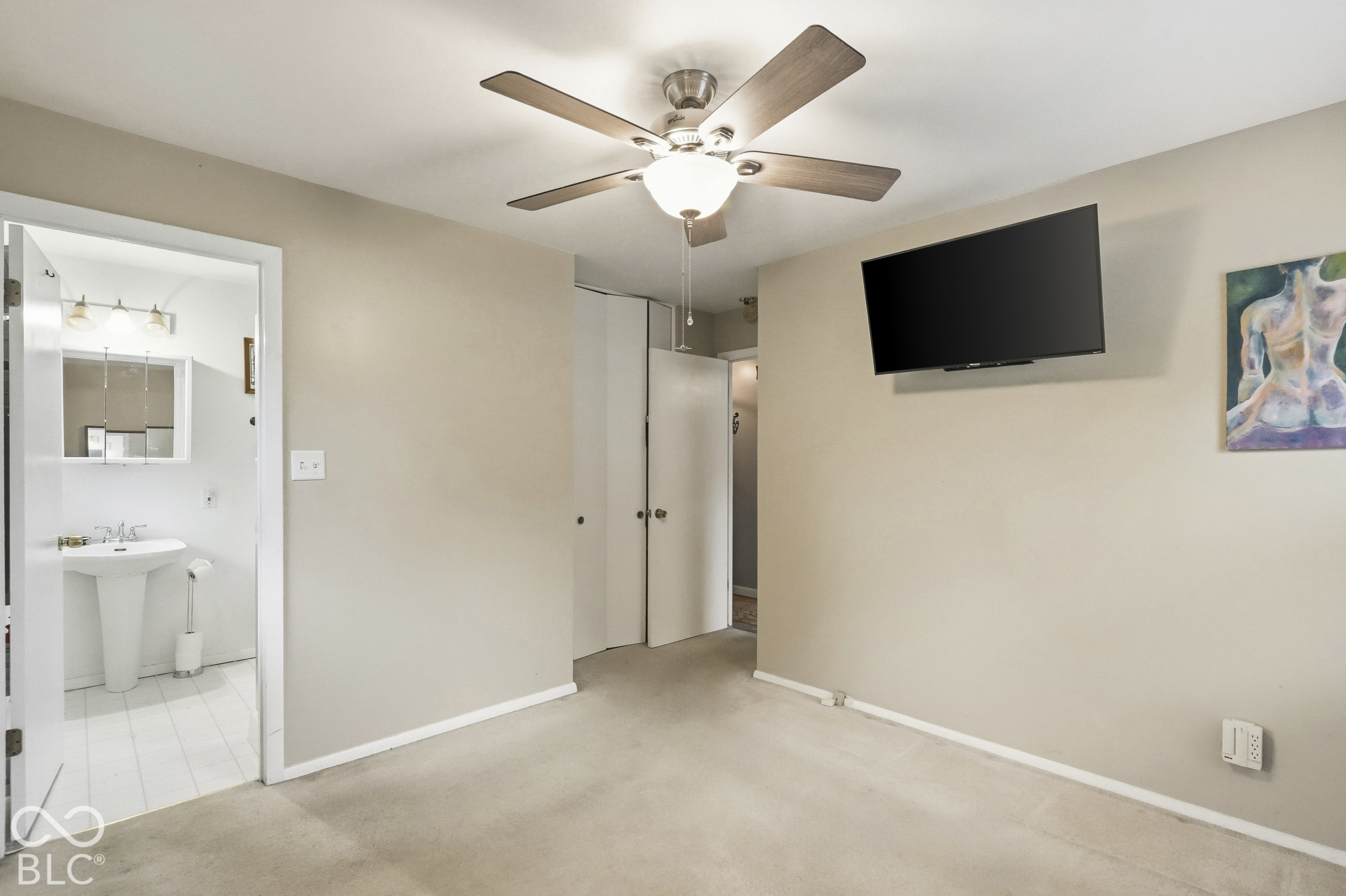 Another view of the primary suite. From this angle you see the entrance to the en-suite bathroom.