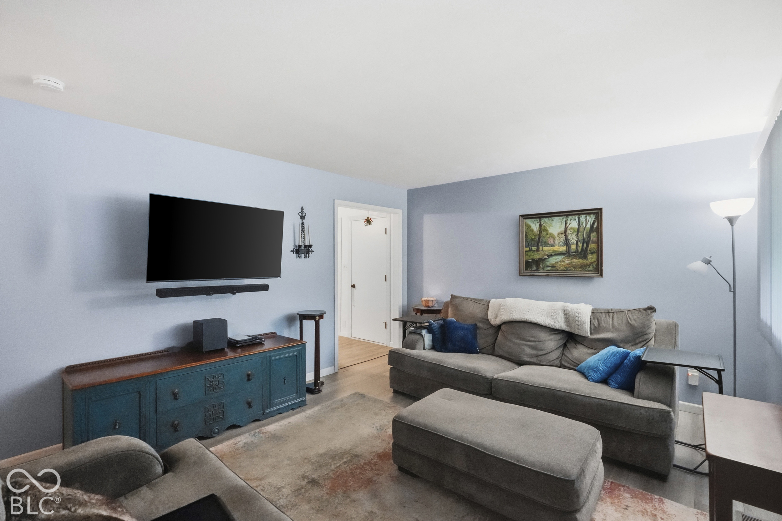 Living area featuring smooth-finish ceilings and vinyl plank flooring.