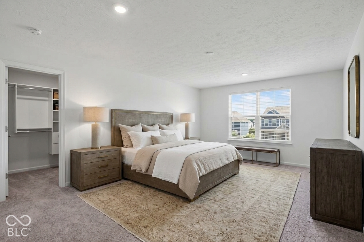 Virtually Altered - Bedroom featuring wall-to-wall carpeting, recessed lighting, and a walk-in closet with built-in shelving