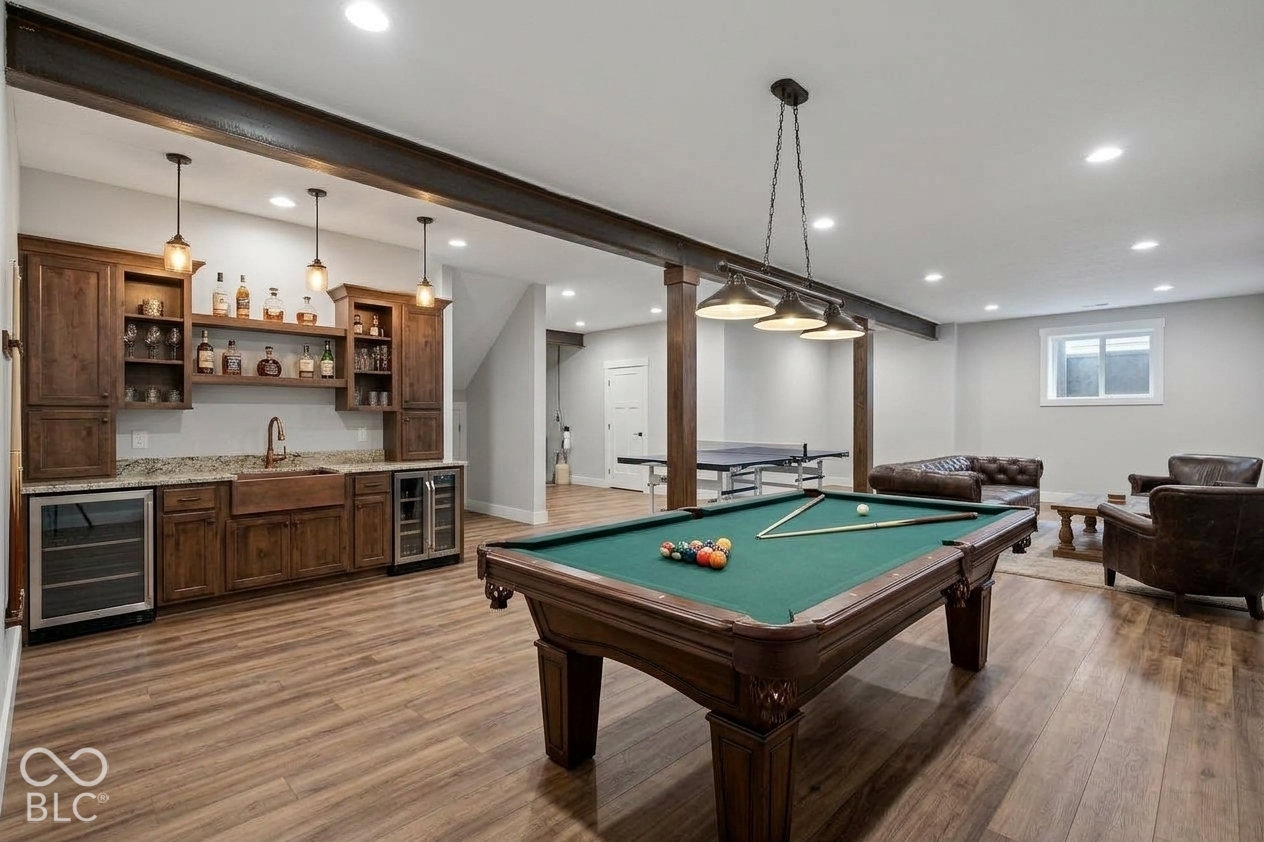 Virtually Altered - Custom wet bar featuring stained wood cabinetry, stone-style countertops, an undermount copper farmhouse sink, and built-in beverage refrigeration