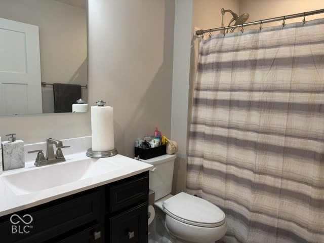 Dark-finished vanity with an integrated white sink, white countertop, chrome faucet hardware, and a wall-mounted mirror
