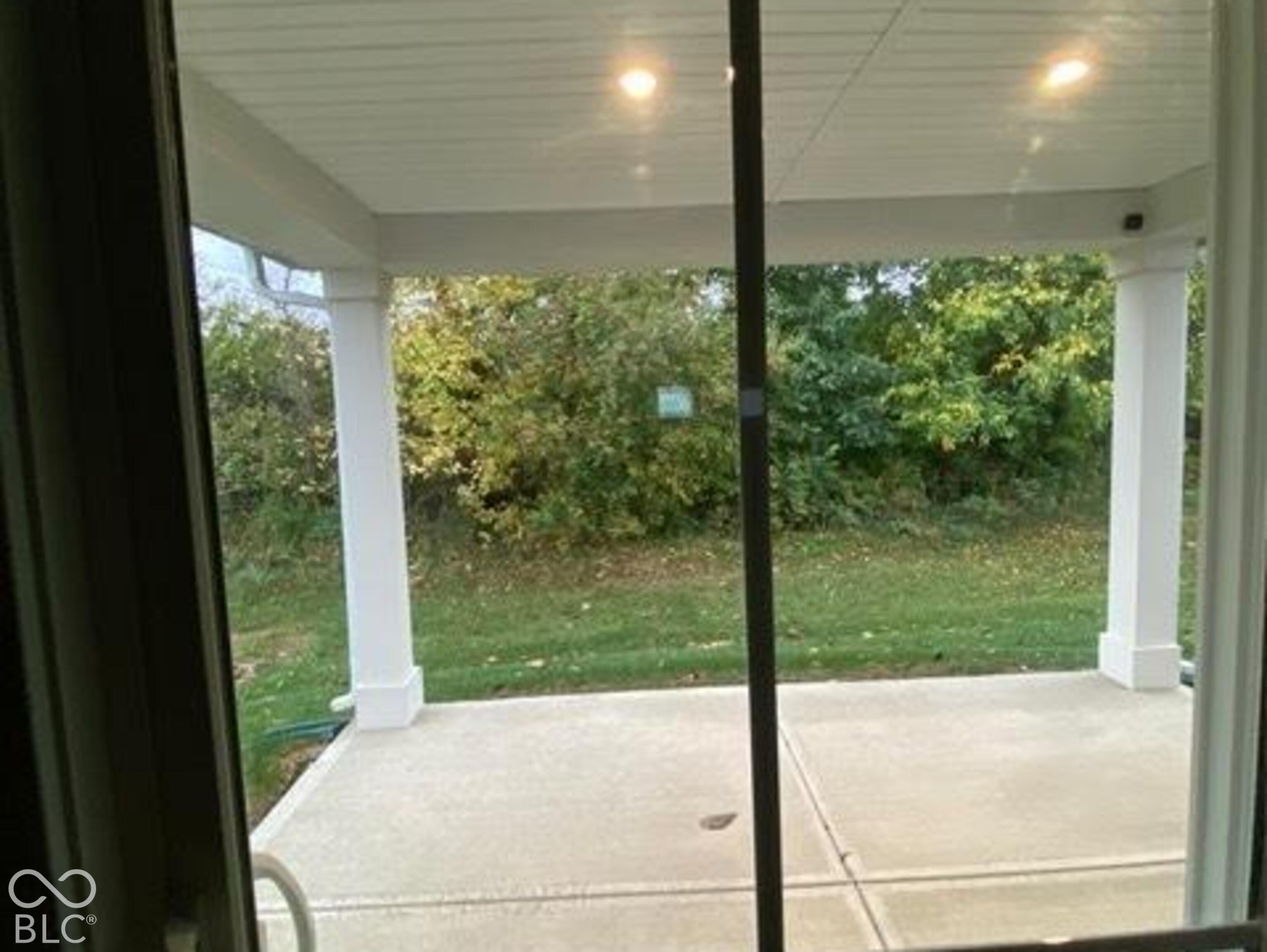 Covered concrete patio featuring recessed ceiling lighting, square structural columns, and a beadboard ceiling finish