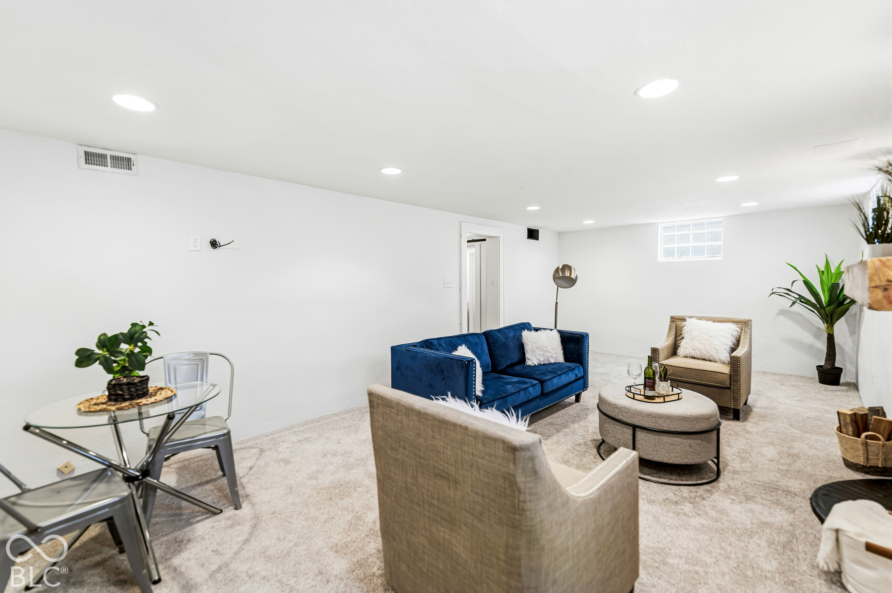 Finished lower level featuring recessed lighting, neutral carpeting, and a glass block window