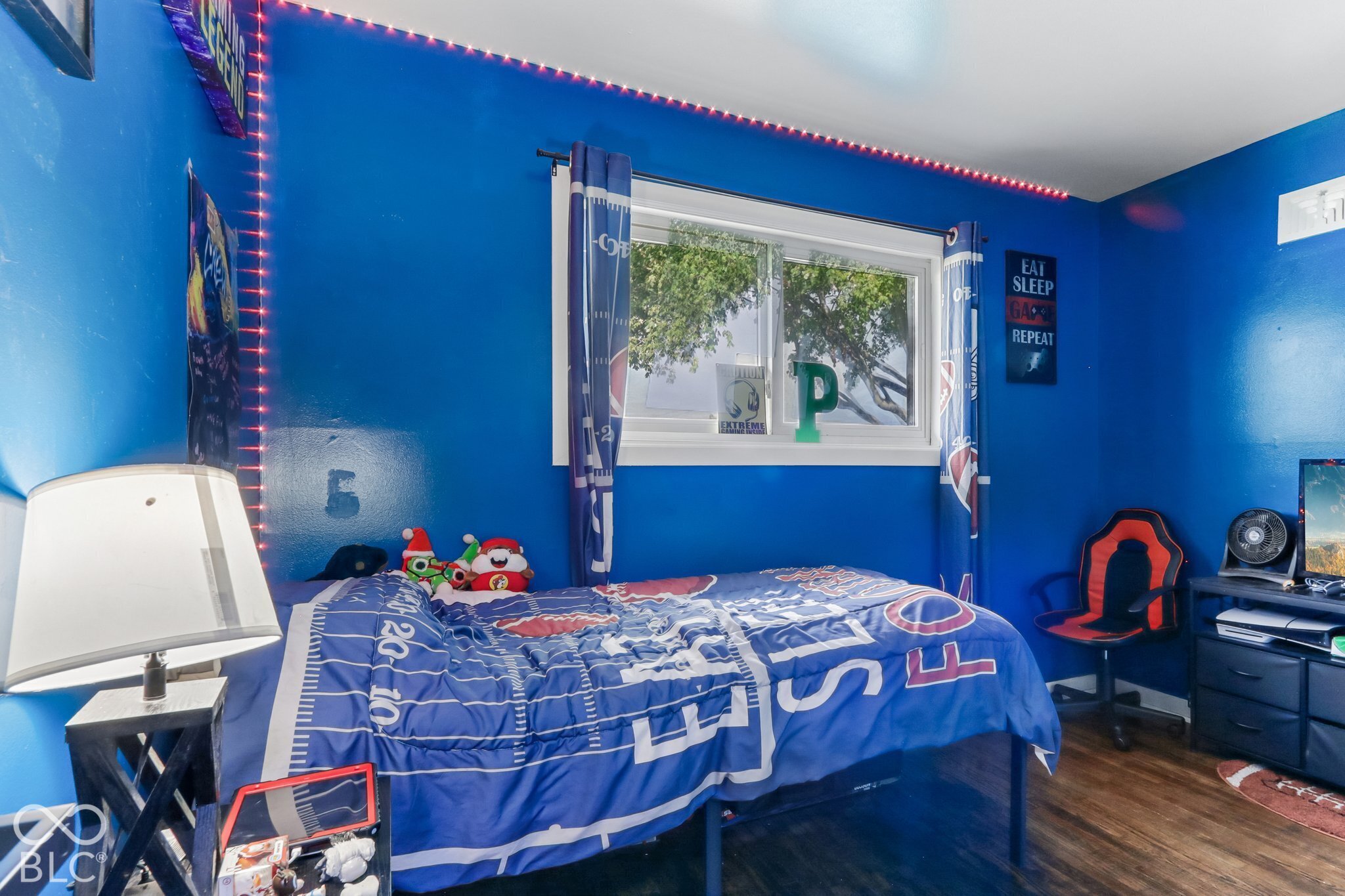 Bedroom featuring a double-pane horizontal sliding window with white trim and wood-finish flooring