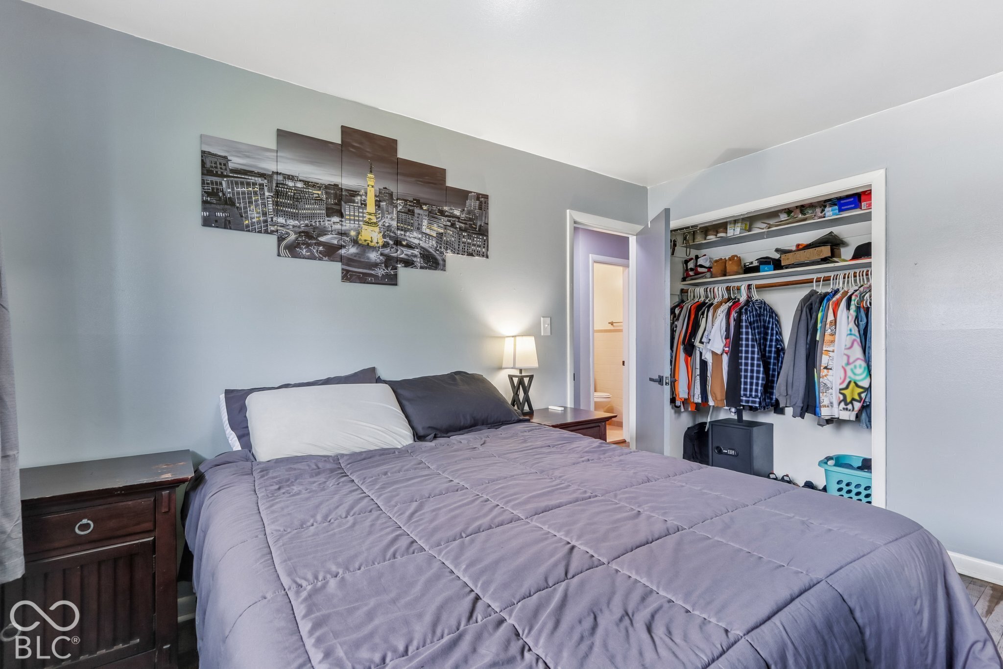 Bedroom featuring neutral-toned wall paint and an integrated reach-in closet with built-in shelving and a hanging rod
