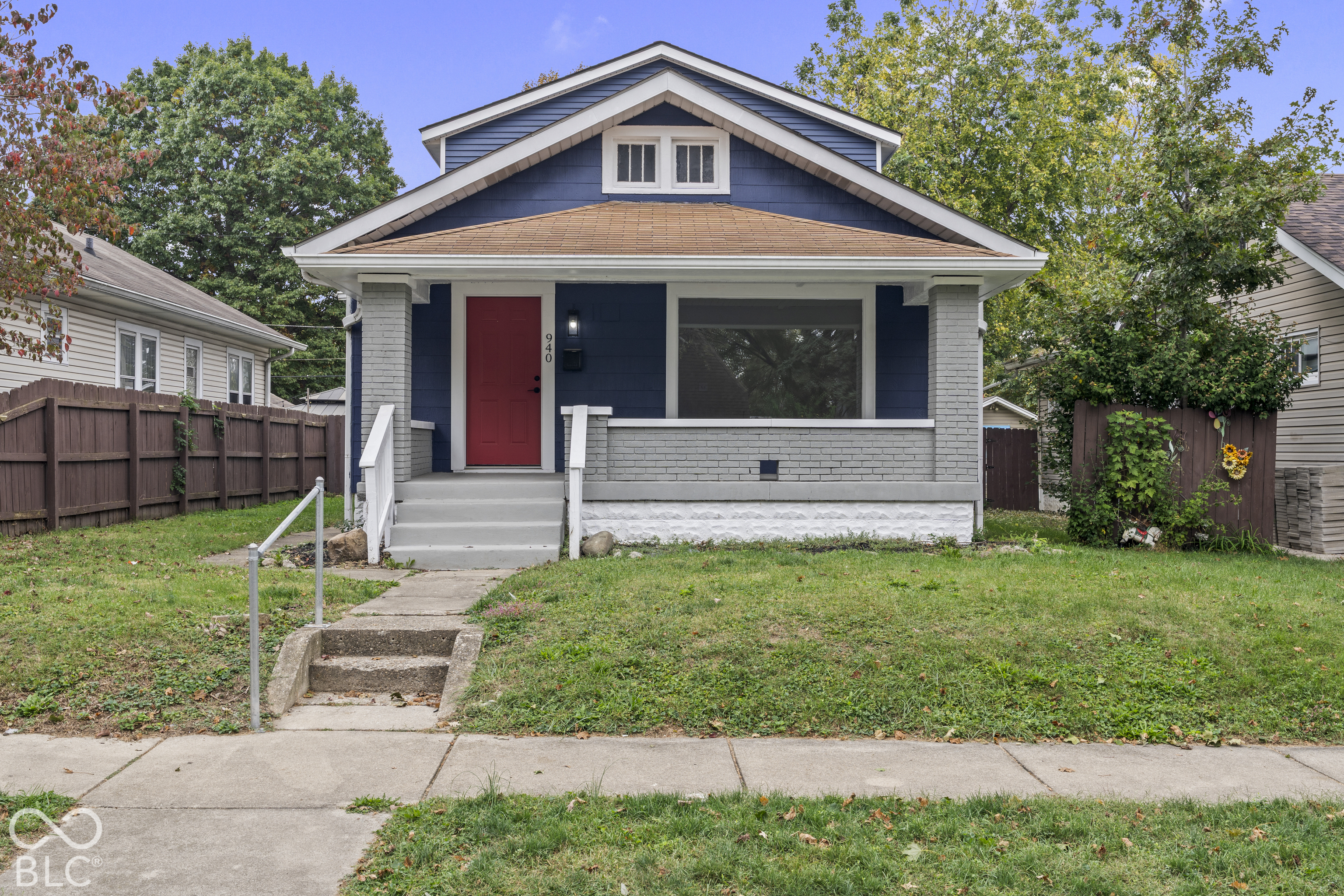 Craftsman-style exterior featuring lap siding, a front porch with brick pillars, and a concrete walkway Craftsman-style exterior featuring lap siding, a front porch with brick pillars, and a concrete walkway