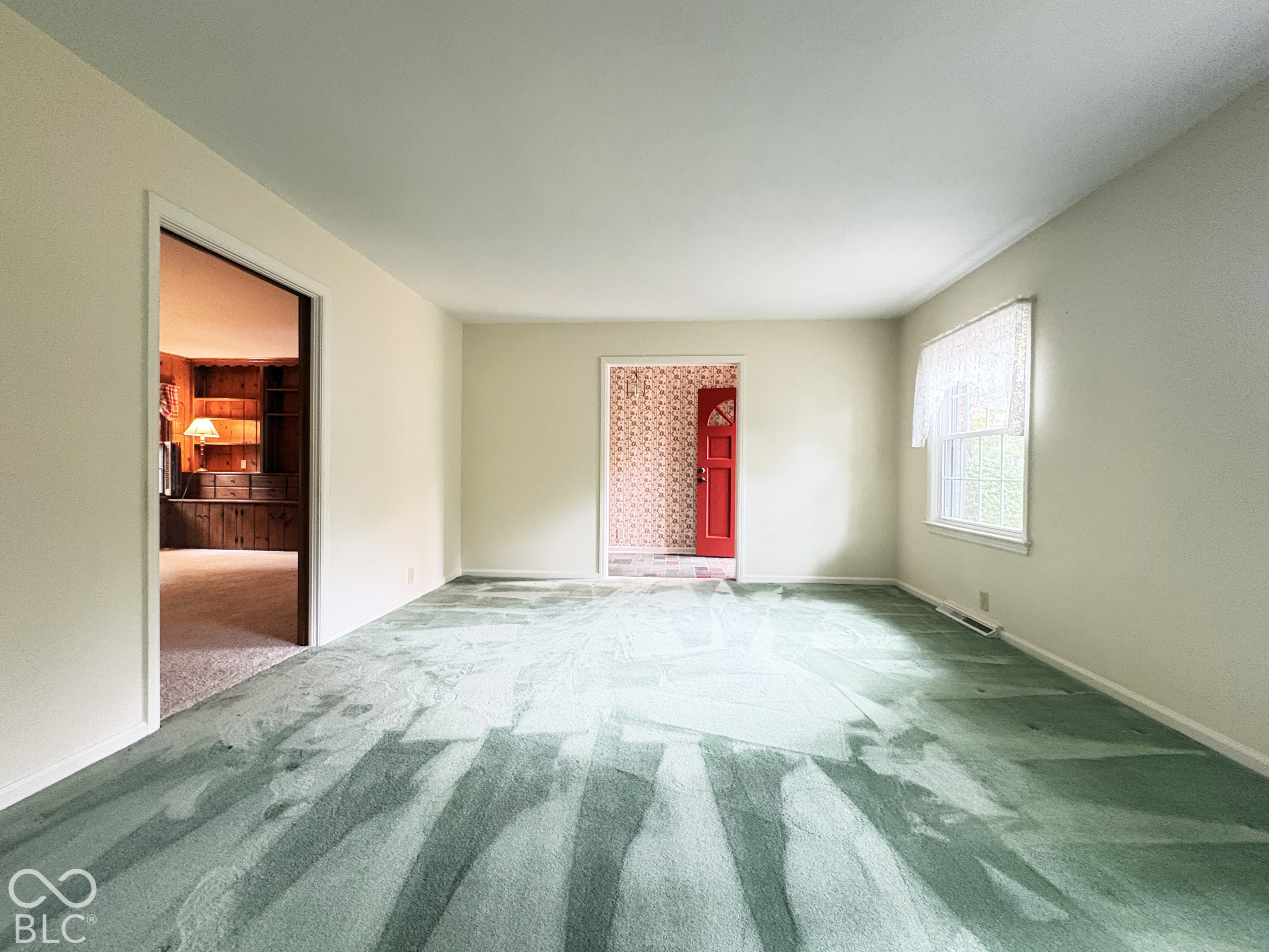 Large 17' x 13' living or dining room as you enter home.  There is hardwood floor under the carpet.