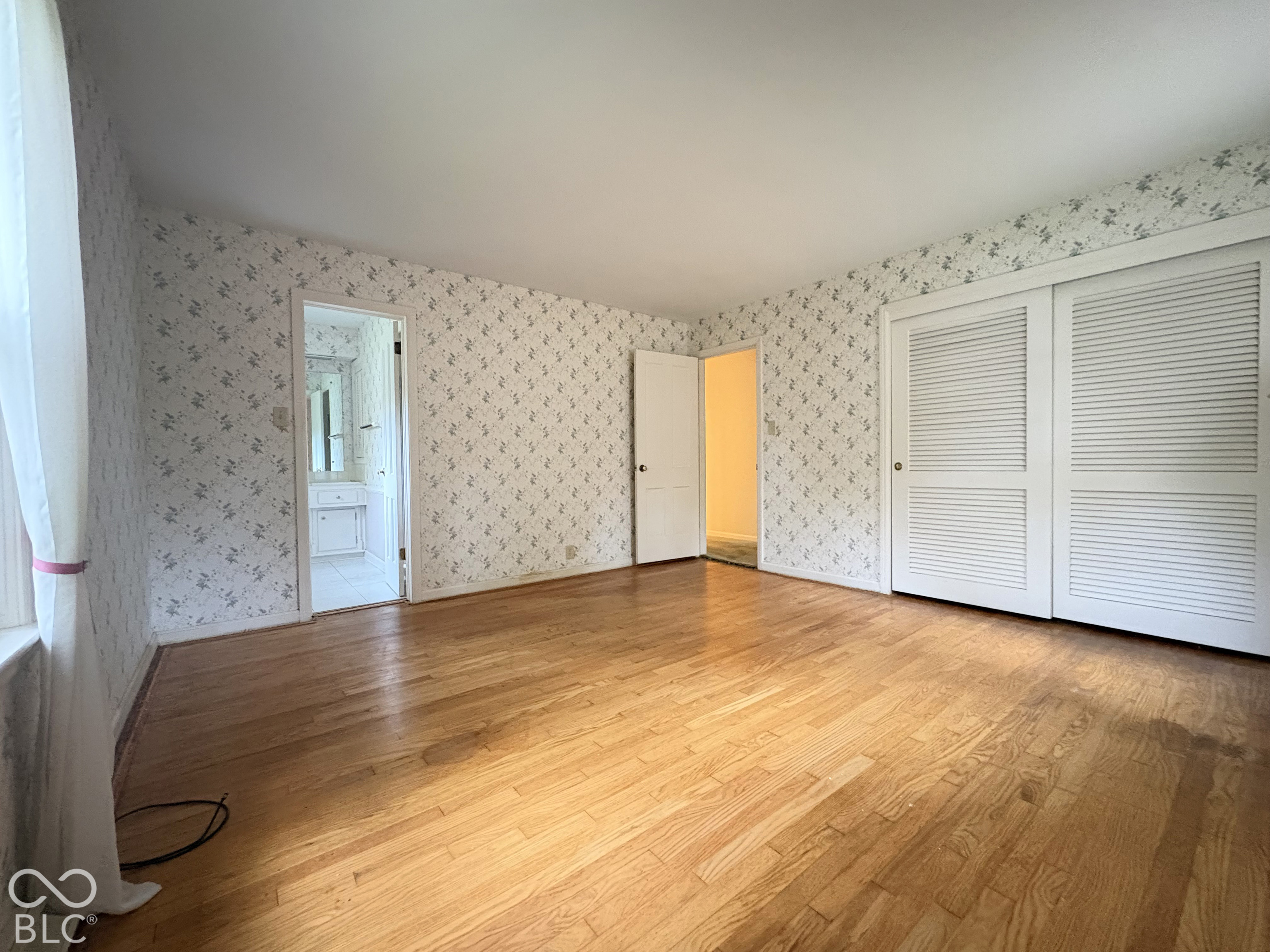 The carpeting has been removed so buyer can see quality of the hardwood floors.