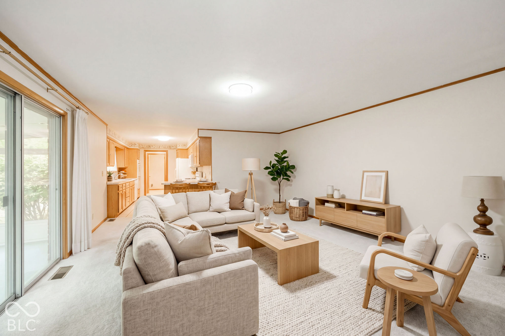 Virtually Altered - Open-concept interior featuring wall-to-wall carpeting, sliding glass doors, and crown molding. Virtually Staged. Virtually Altered - Open-concept interior featuring wall-to-wall carpeting, sliding glass doors, and crown molding. Virtually Staged.
