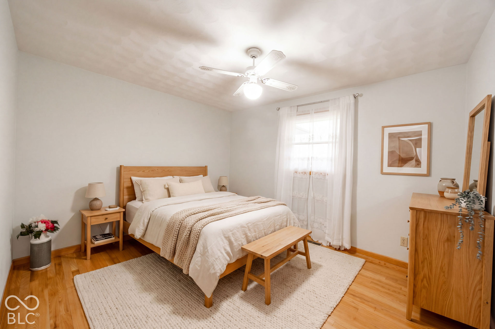Virtually Altered - Room featuring wood-finish flooring, a central ceiling fan with integrated lighting. Virtually Staged.