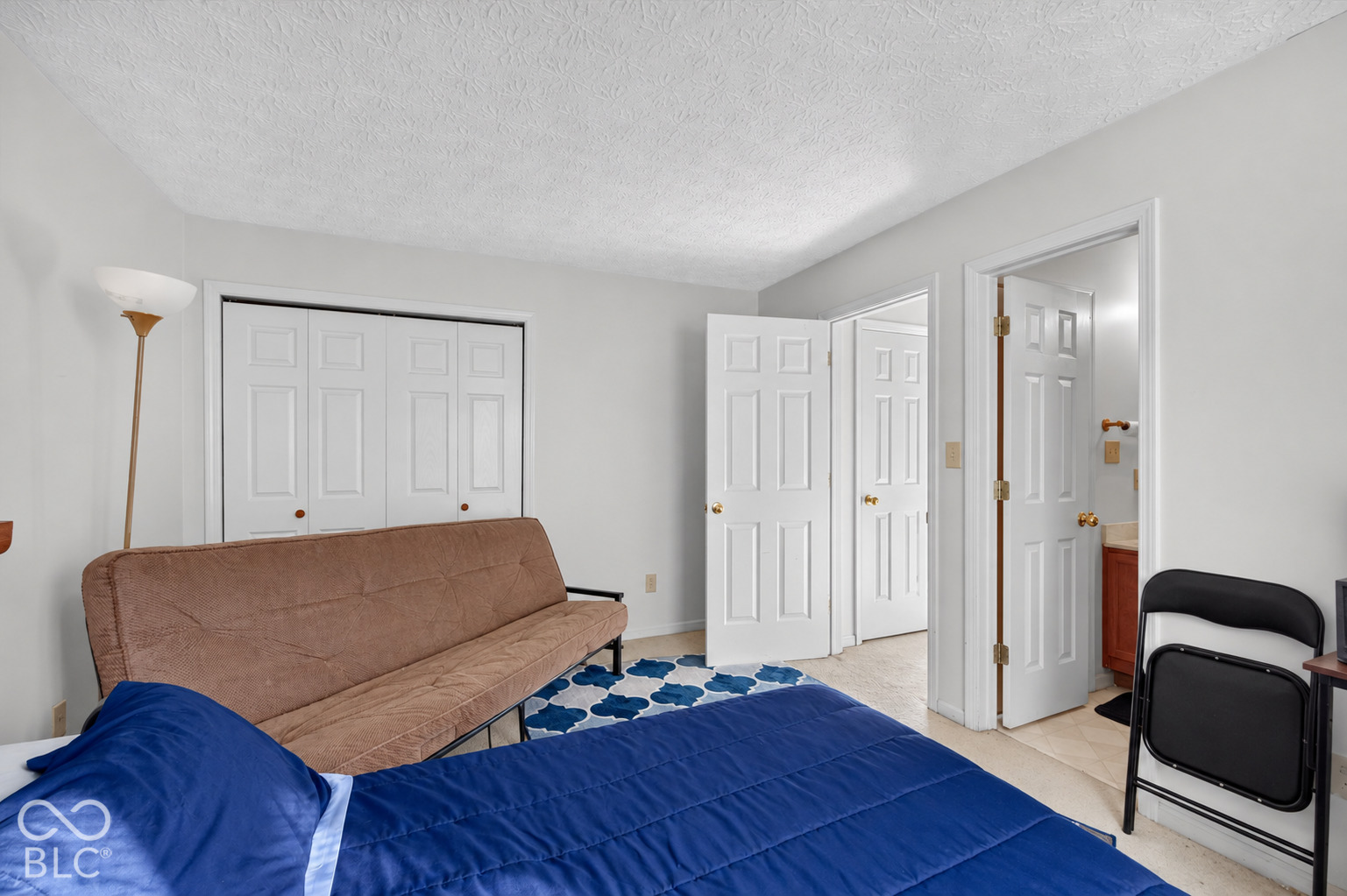 Interior room featuring a double-door closet, six-panel interior doors, and tile flooring