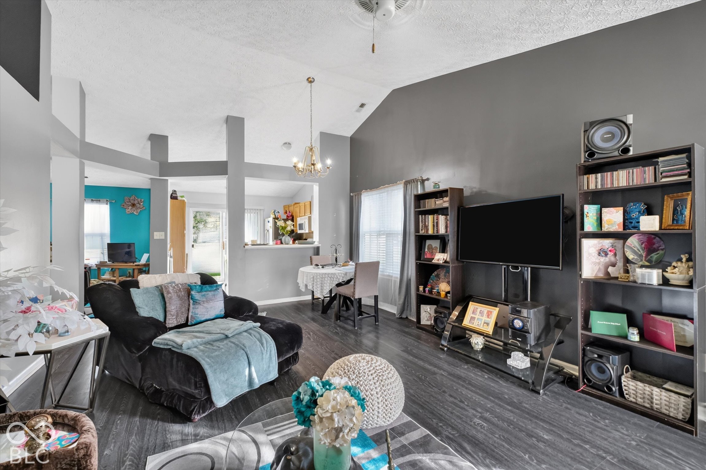 Vaulted ceilings, wood-finish flooring, and a multi-tiered structural partition
