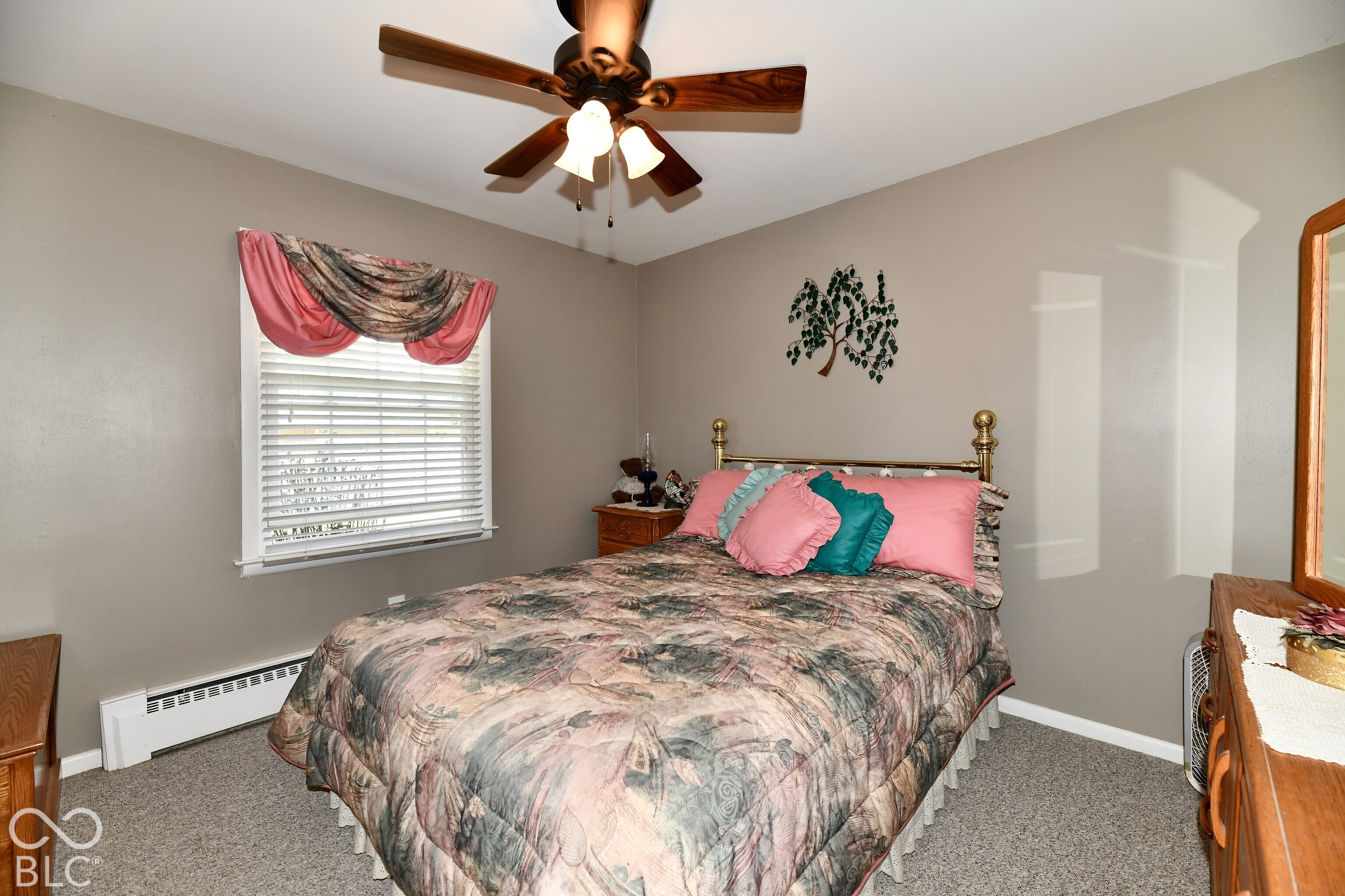 Neutral wall finish, window with horizontal blinds, and ceiling fan with integrated light fixture