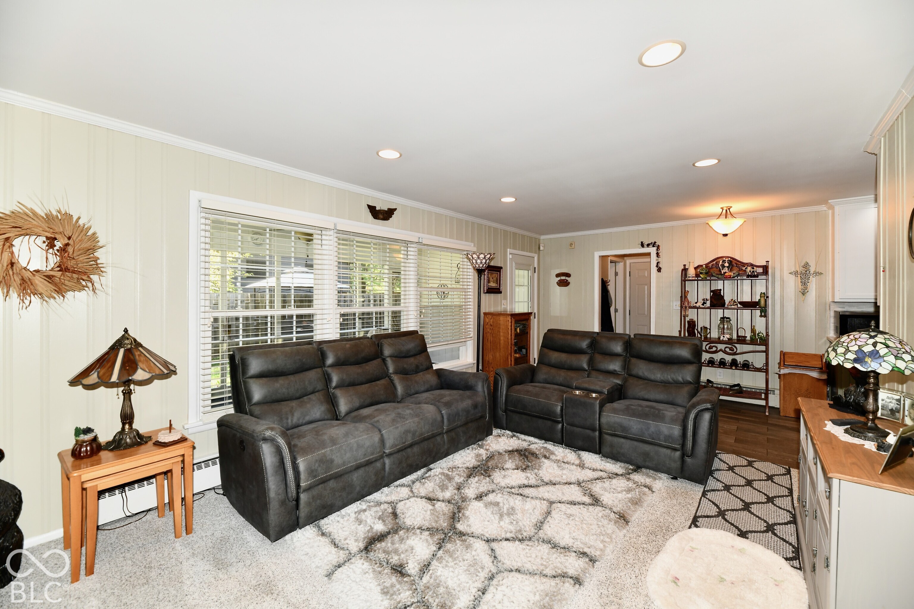 Living area featuring recessed lighting, paneled walls, and expansive triple-pane window installation
