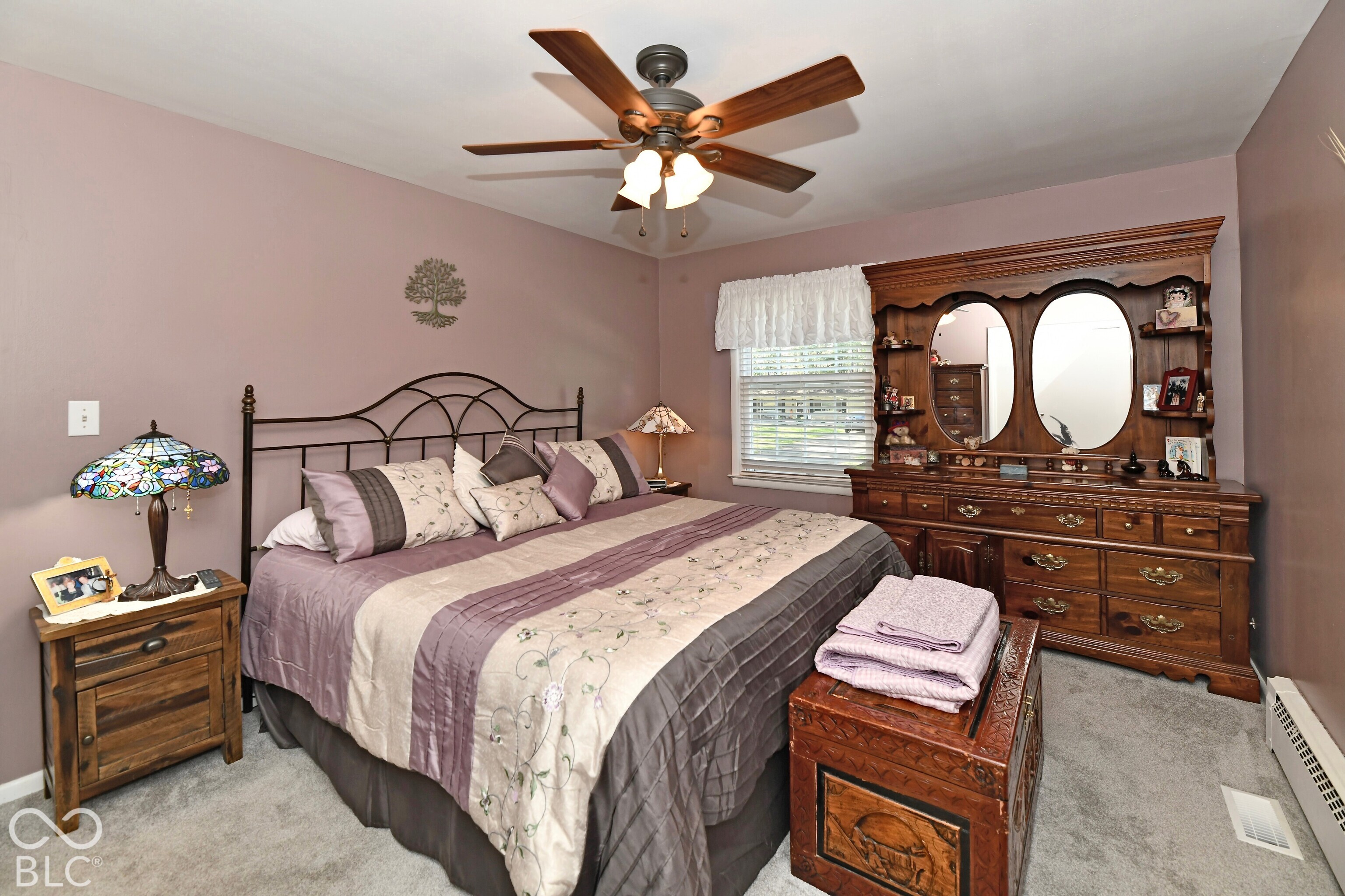 Bedroom featuring neutral wall paint, wall-to-wall carpeting, and a ceiling-mounted light fixture with a five-blade fan