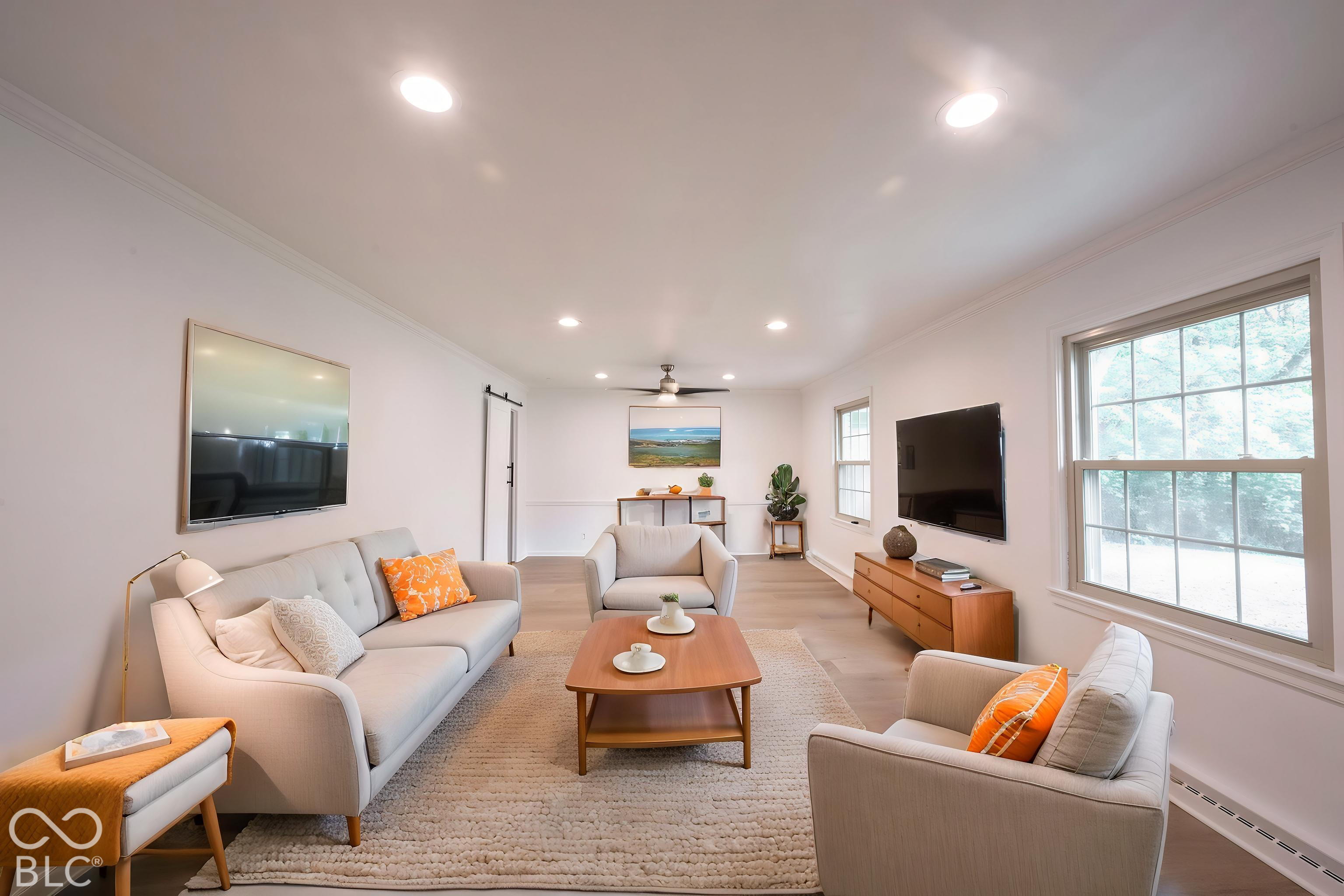 Living area featuring recessed lighting, wood-finish flooring, a ceiling fan, and a sliding barn door