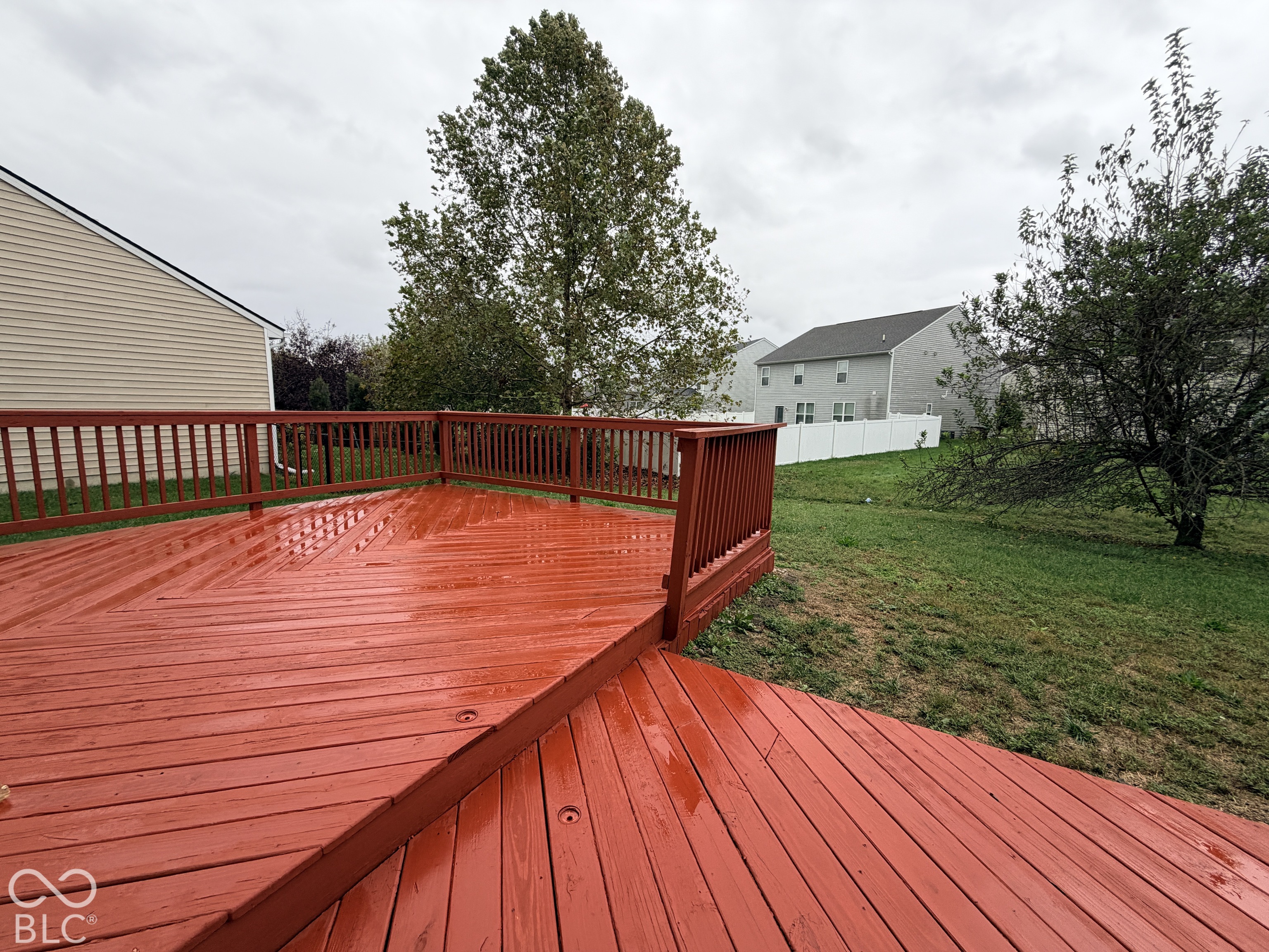 Multi-level wooden deck featuring a diagonal board pattern and perimeter railing