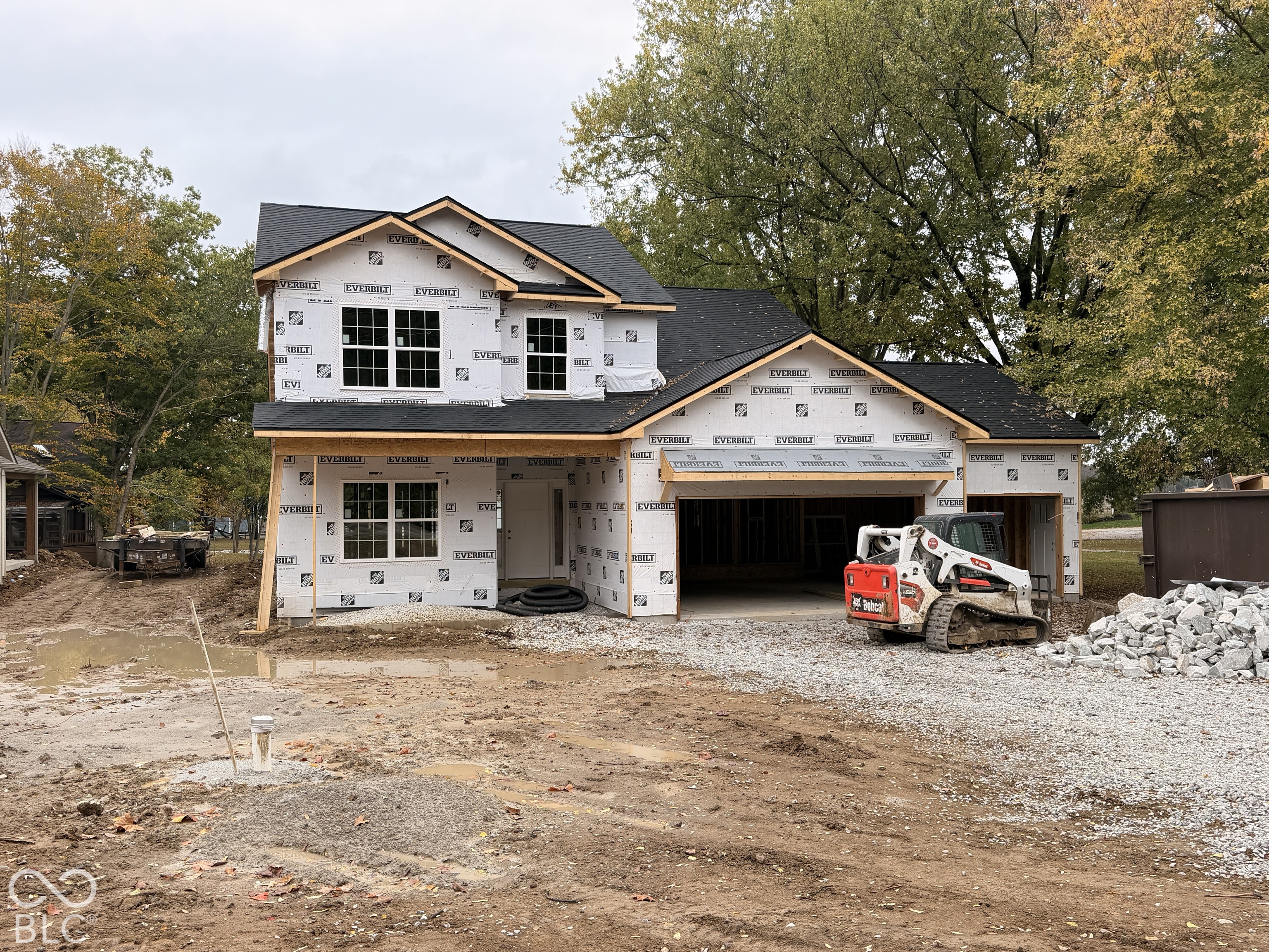 Two-story architectural structure featuring a gabled roofline, multi-pane windows, and an attached two-car garage