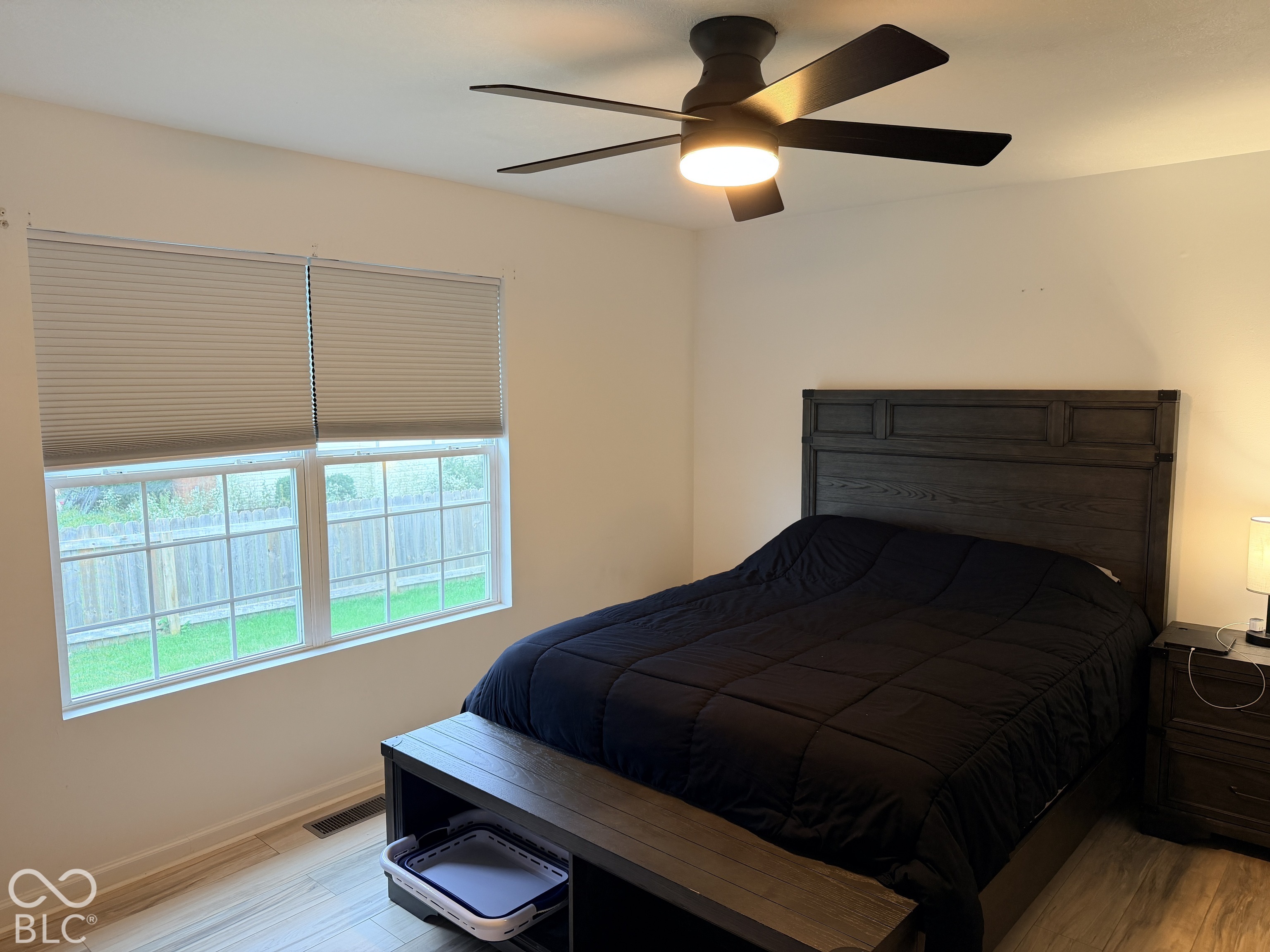 Nice ceiling fan and windows overlooking the fenced back yard..