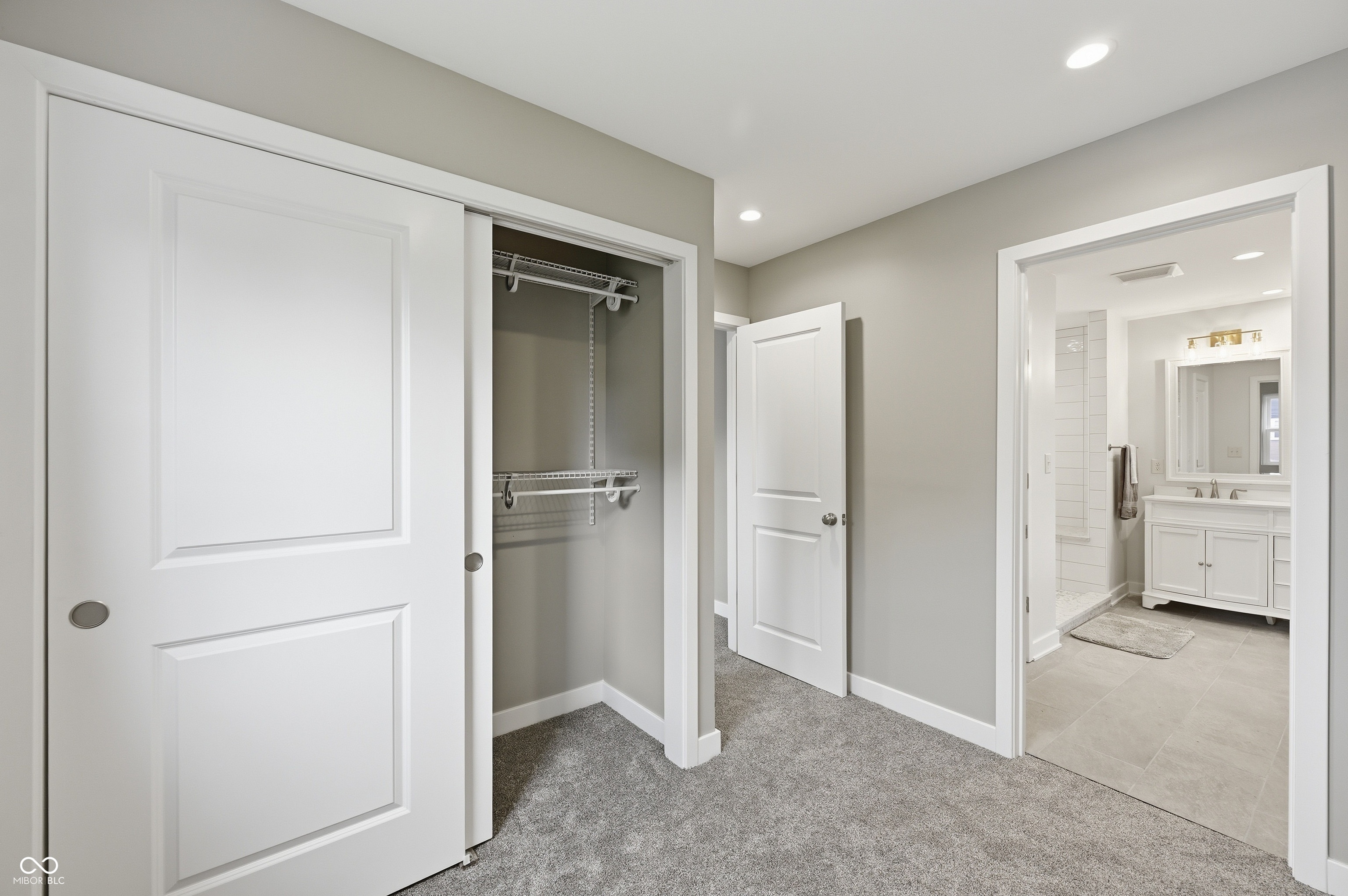 Plush gray carpeting and light gray wall paint