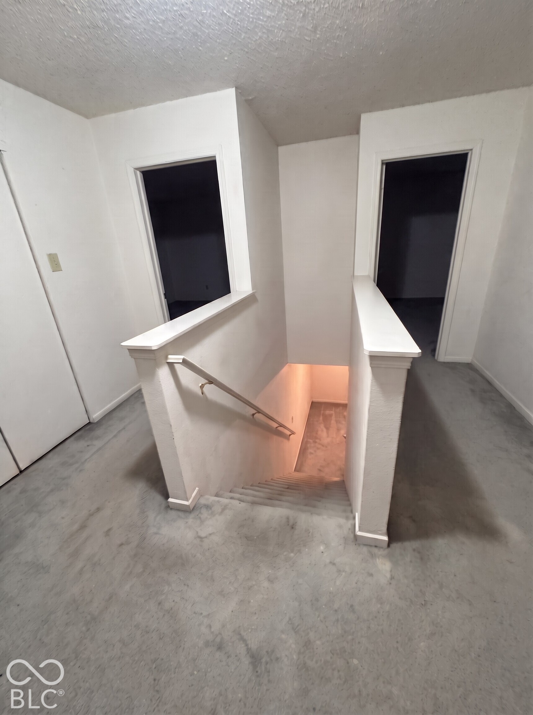 Virtually Altered - Staircase featuring neutral carpeting, painted walls, and a metal handrail