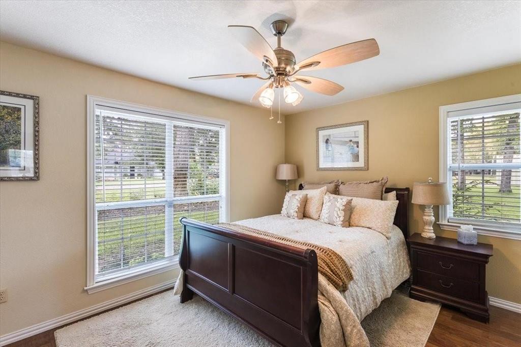 Bedroom with ceiling fan, baseboards, and wood finished floors
