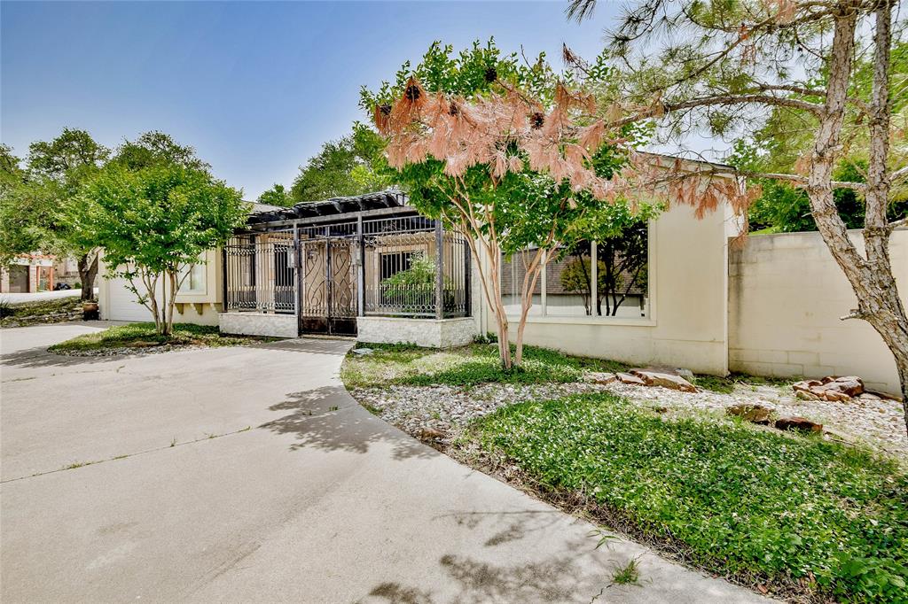 View of front facade featuring concrete driveway, an attached garage, and stucco siding View of front facade featuring concrete driveway, an attached garage, and stucco siding