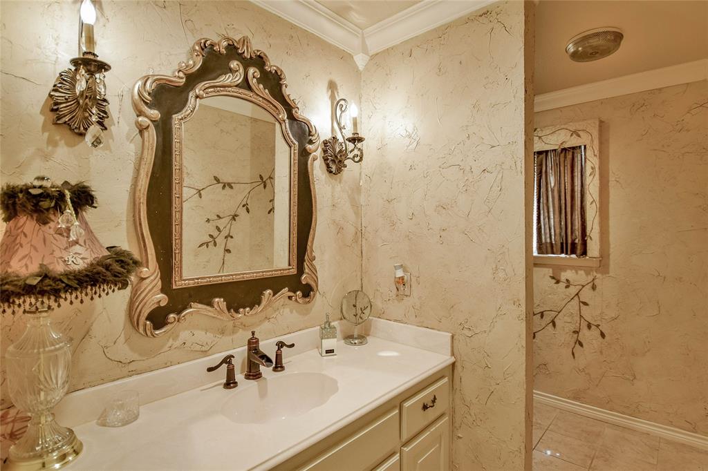 Bathroom featuring vanity, ornamental molding, baseboards, and tile patterned floors