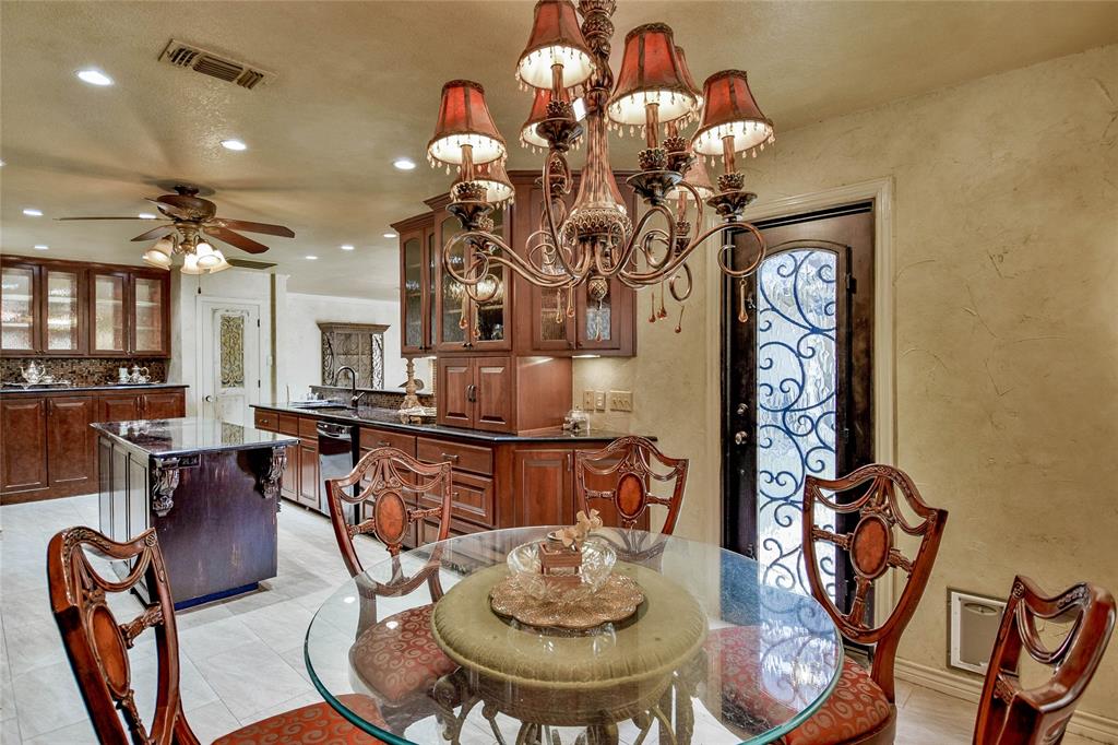 Dining area with a textured wall, recessed lighting, a chandelier, a ceiling fan, and light tile patterned floors