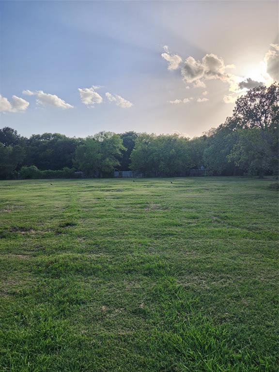 View of grassy yard with a wooded view and a view of countryside View of grassy yard with a wooded view and a view of countryside