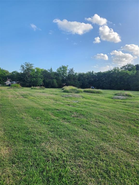 View of grassy yard featuring a view of countryside and a wooded view View of grassy yard featuring a view of countryside and a wooded view