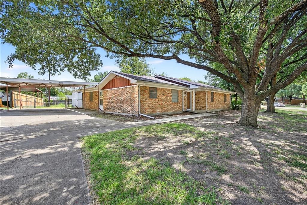 View of side of property with concrete driveway and brick siding