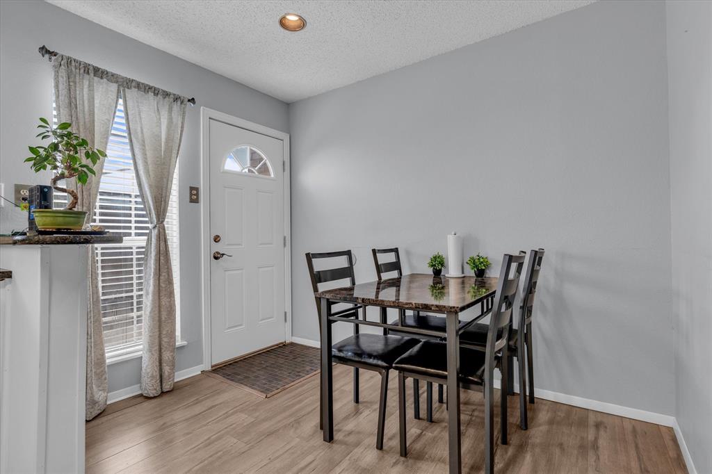 Dining space featuring a textured ceiling and light wood-style flooring