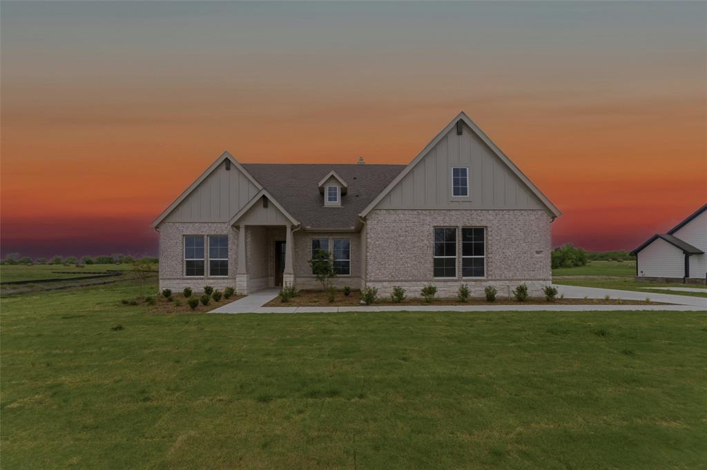 Craftsman inspired home with board and batten siding, brick siding, and a lawn Craftsman inspired home with board and batten siding, brick siding, and a lawn
