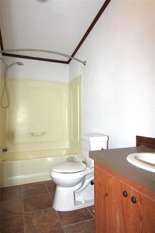 Bathroom #2featuring vanity, shower / bath combination, and dark tile patterned flooring