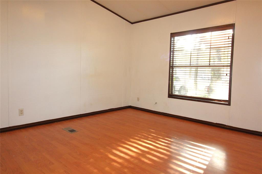 Bedroom #3Spare room featuring light wood-style flooring and crown molding