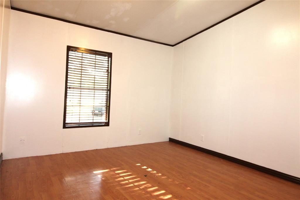Bedroom #2 Spare room featuring wood finished floors