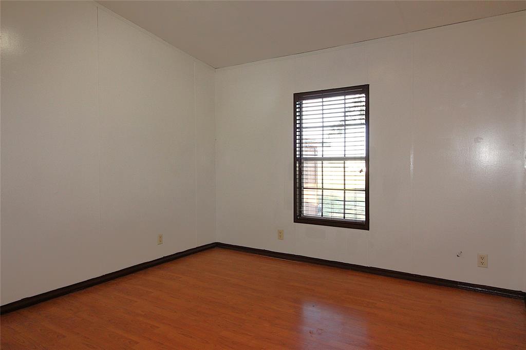 Bedroom #1Unfurnished room with wood finished floors and baseboards