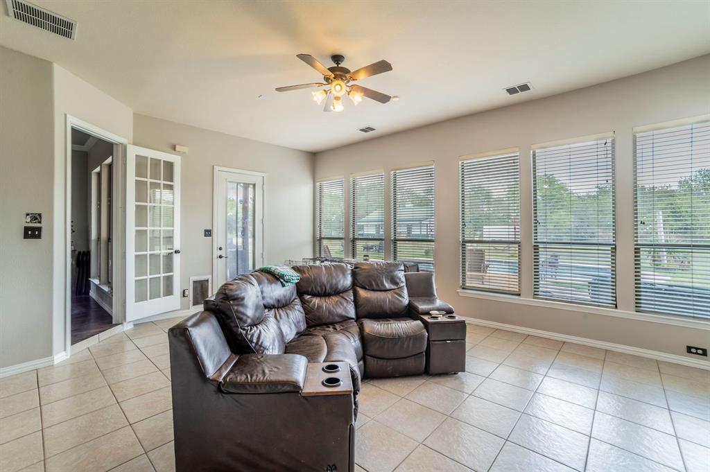 Sunroom overlooks the pool, patio and back yard area.