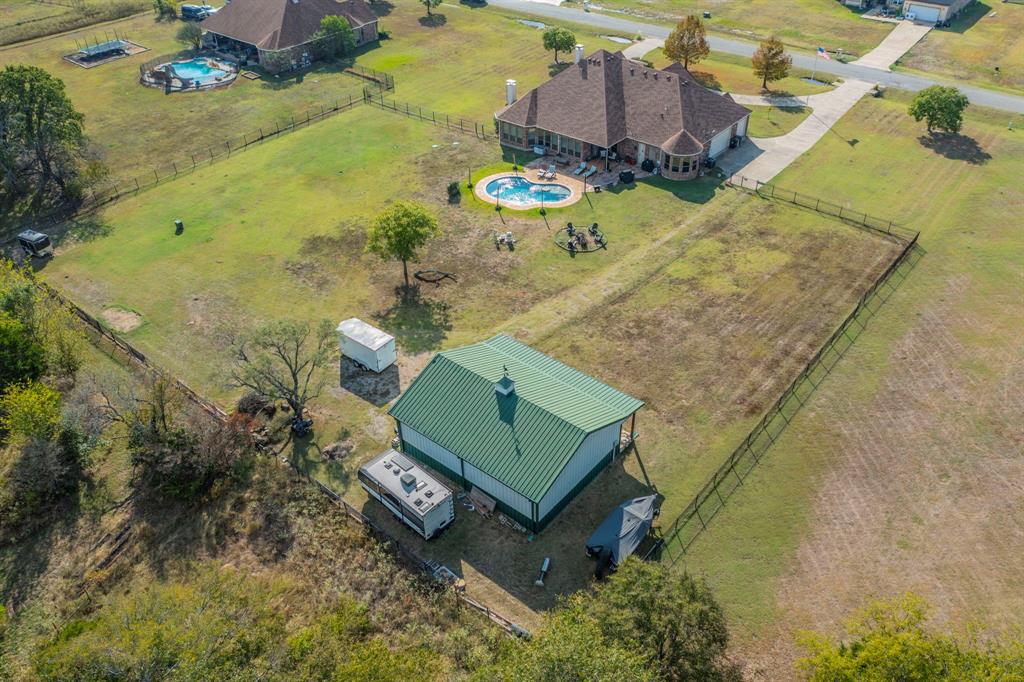 View of rural area featuring a pool and a pastoral area