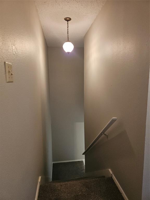 810 - Stairs down to landing with light above.