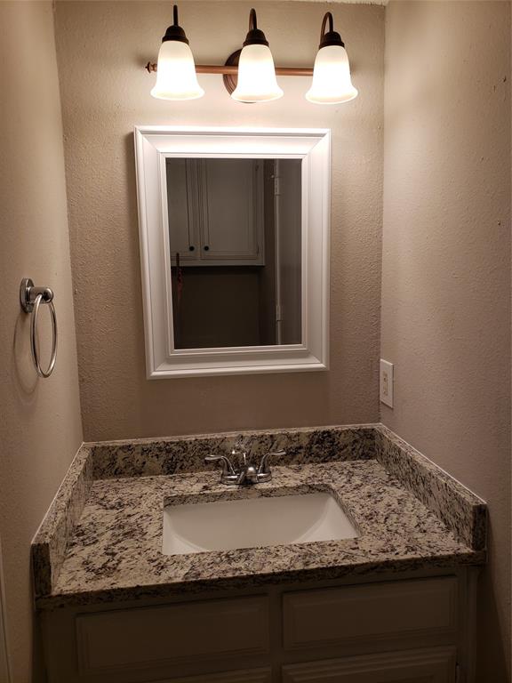808 - Downstairs vanity, sink, mirror, across from toilet; walkthrough to utility area. 808 - Downstairs vanity, sink, mirror, across from toilet; walkthrough to utility area.