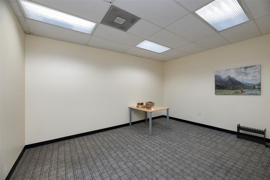 Spare room featuring baseboards and a drop ceiling
