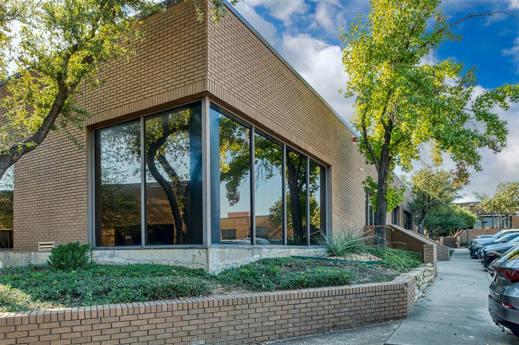View of side of home with brick siding and a sunroom View of side of home with brick siding and a sunroom