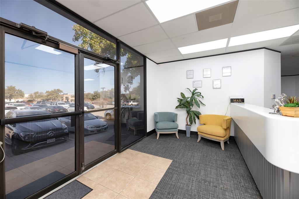 Community lobby featuring a drop ceiling and a wall of windows Community lobby featuring a drop ceiling and a wall of windows