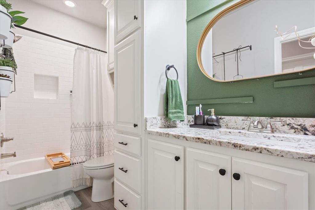 Bathroom with vanity and shower / tub combo
