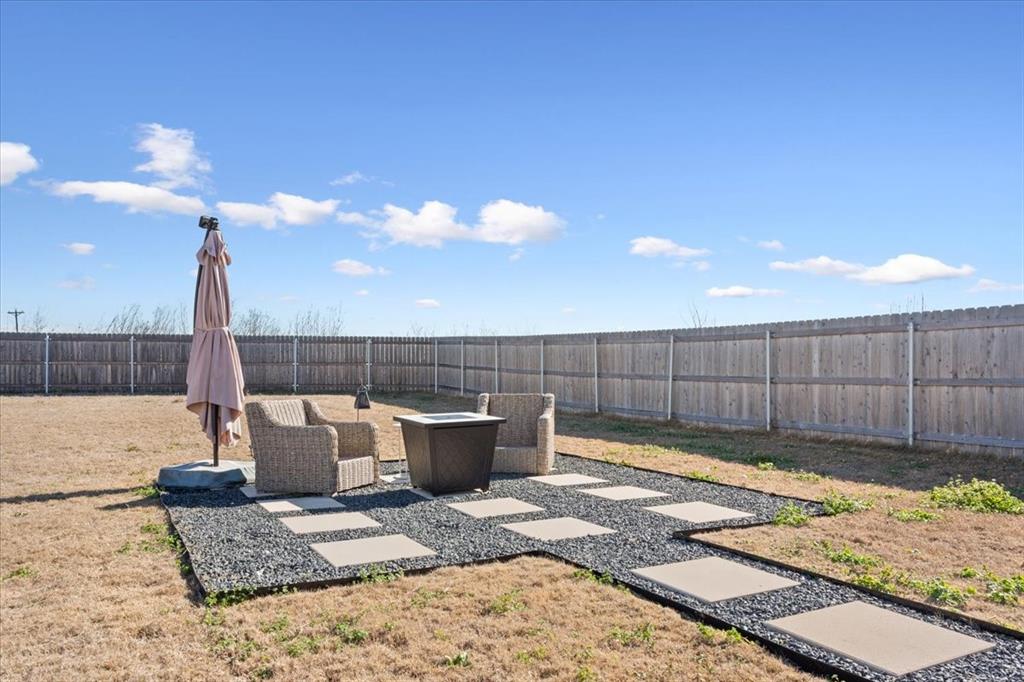 Fenced backyard with a patio