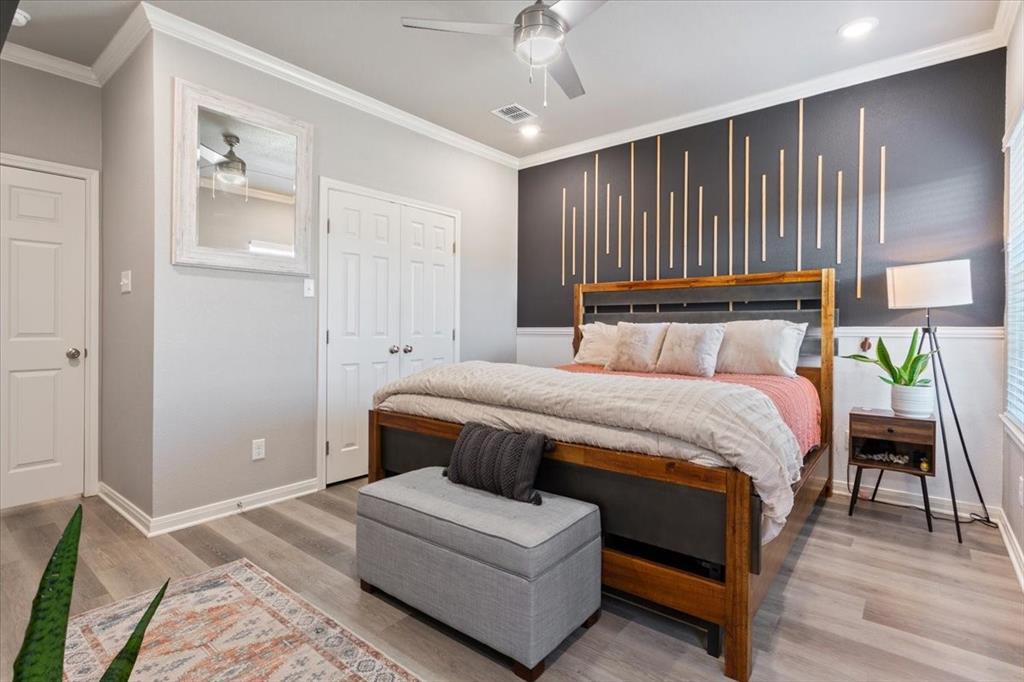 Bedroom with ornamental molding, light wood-type flooring, a ceiling fan, and recessed lighting